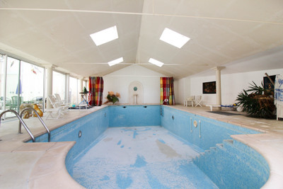 Stunning six-bedroomed mansion. Lift, indoor swimming-pool complex, outbuildings, private grounds.