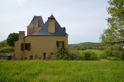 An unspoilt, authentic, medieval to renaissance castle with outbuildings above a river valley within 25 ha.