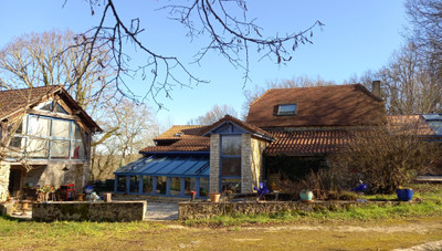 Stone house with a modern extension, 17 hectares of woods and fields, swimming pool and outhouses to renovate